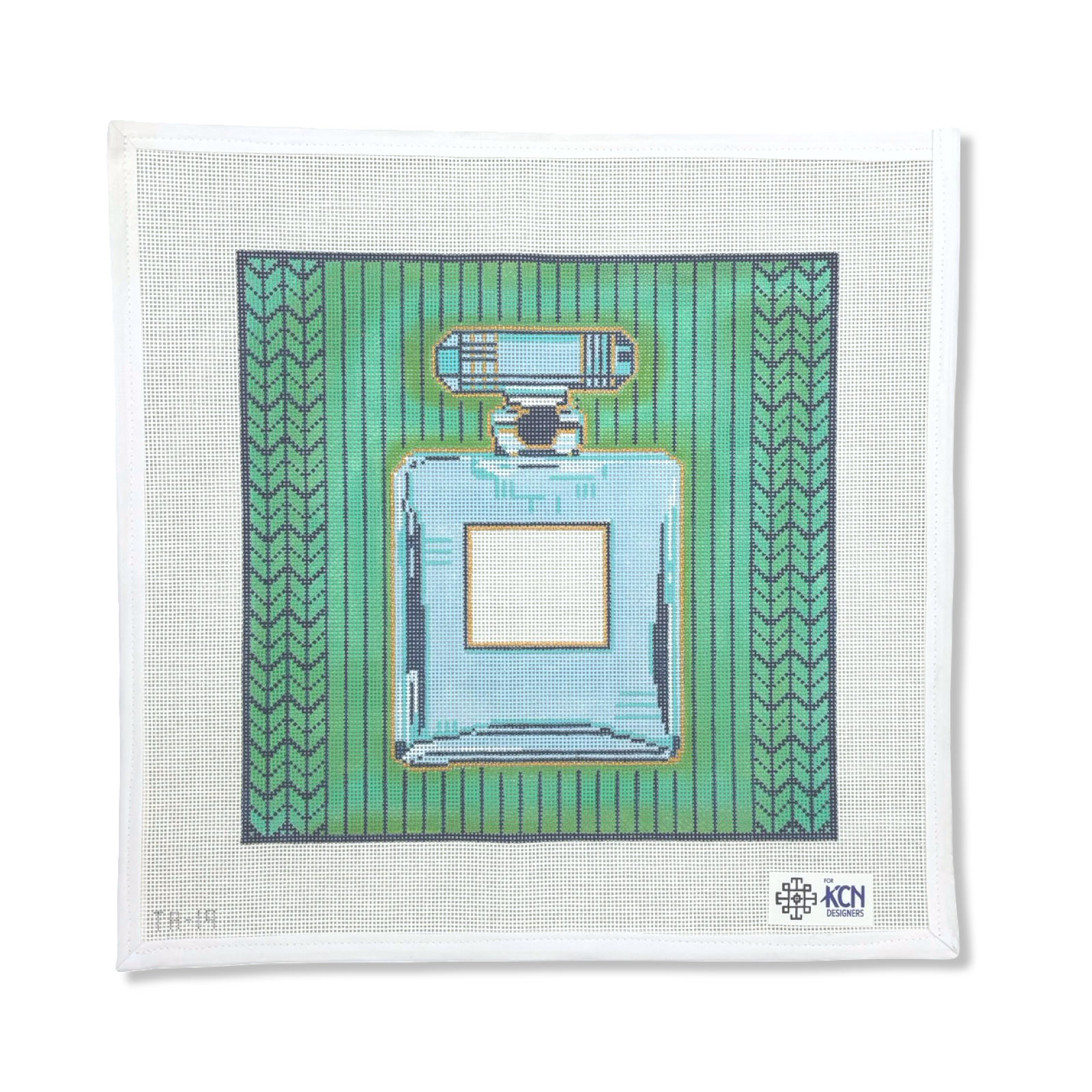 PERFUME BOTTLE ON GREEN