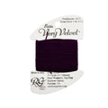 Spool of purple thread on a white background with a label